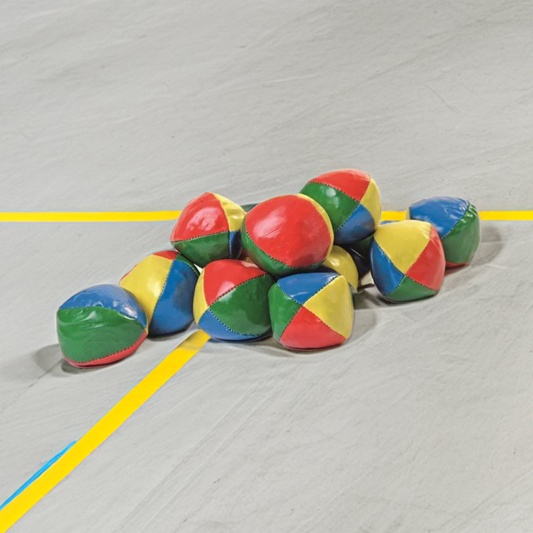 Colorful set of 12 soft juggling balls in red, blue, yellow, and green, with a slightly cubic shape for stability.