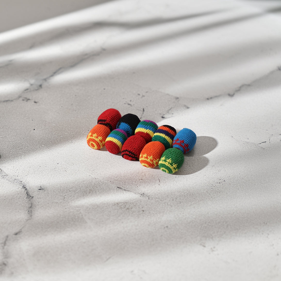 Colorful set of 10 hand-crocheted juggling and stress-relief balls with unique ethnic patterns, soft texture, and vibrant hues.