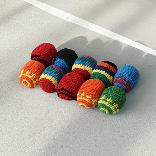 Vibrant set of 10 hand-crocheted juggling and stress-relief balls, each with unique multicolored ethnic patterns, soft and lightweight.