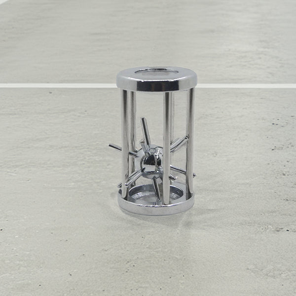 Sleek metal puzzle featuring a captivating sphere trapped in a cylindrical cage of chrome rods, blending industrial style with brain-teasing fun.