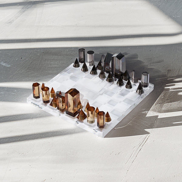 Elegant 37cm crystal chess set with geometric K9 crystal pieces in amber and smoky gray, on a dazzling checkered board.