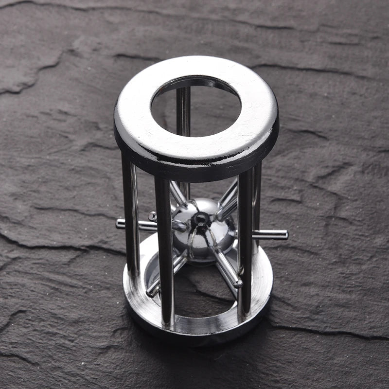 Intriguing metal puzzle featuring a sphere trapped in a cylindrical cage of sleek chrome rods, blending industrial design with brain-teasing fun.