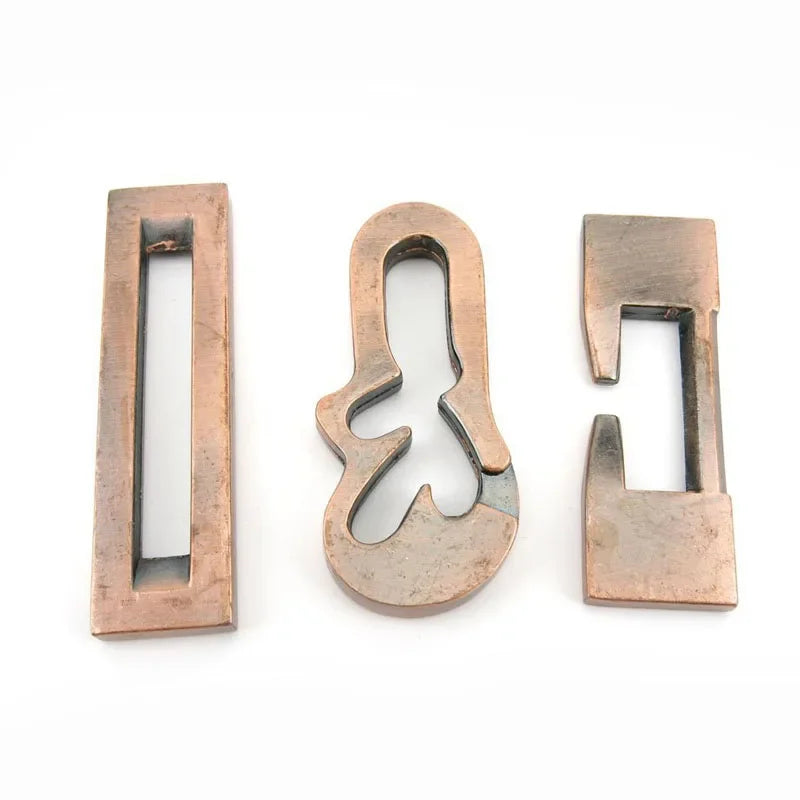Elegant metal violin-shaped puzzle with intricate copper-finished pieces, perfect for brain teasers and stylish decor.