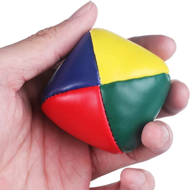 Colorful set of 12 soft juggling balls for beginners, featuring vibrant red, blue, yellow, and green hues with a unique cubic shape for stability.